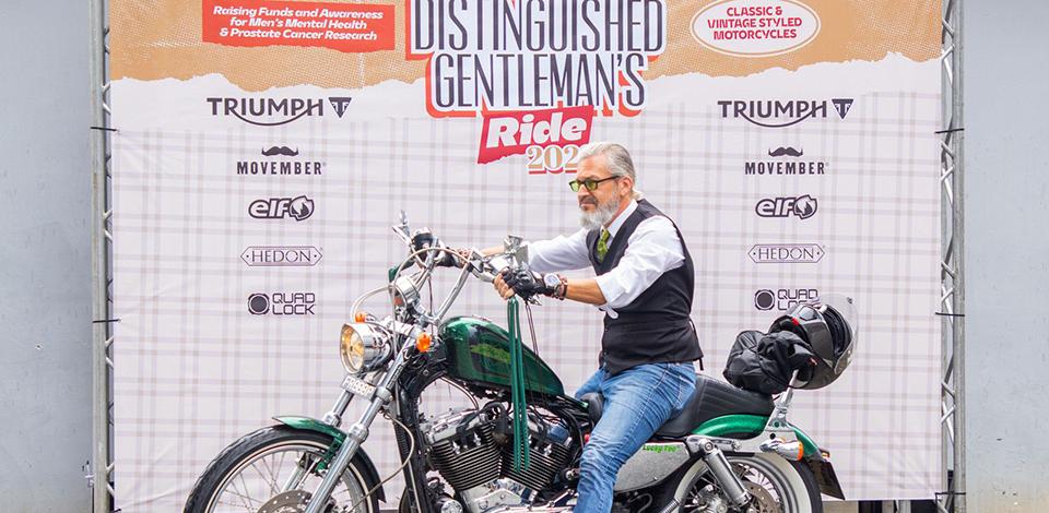 rider riding a harley davidson chopper in front of DGR 2023 backdrop
